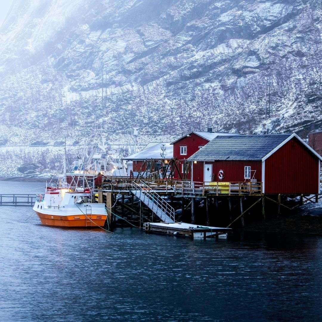 Scenic Winter View of Hamnøy's Red Cottages in Norway