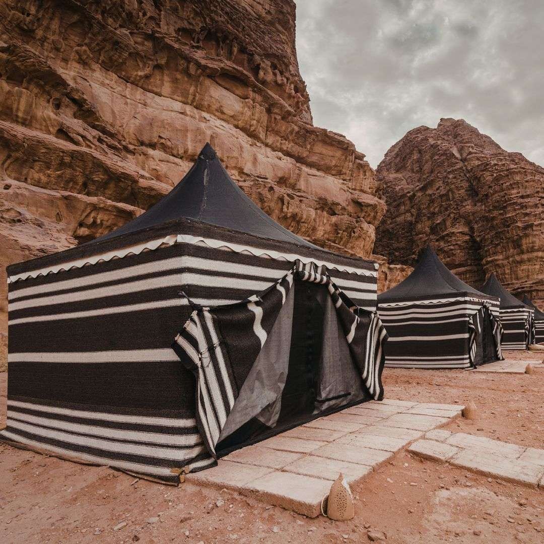 Traditional bedouin tents in a desert canyon landscape