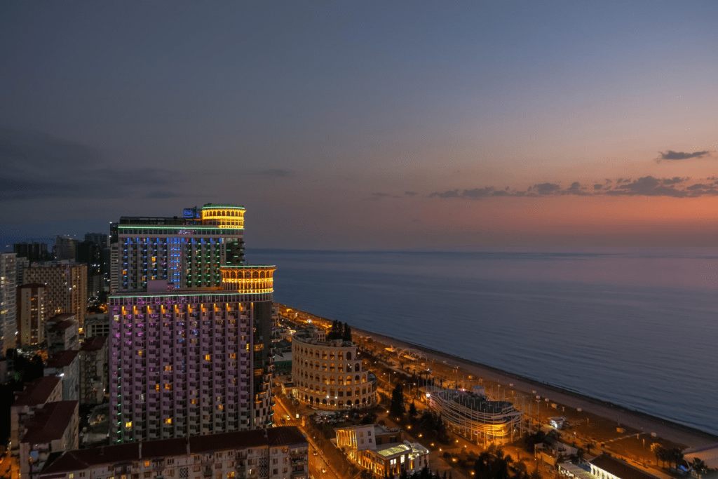 Evening cityscape of Batumi, Georgia with Black Sea at twilight